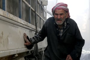 A man in al-Sukkari district after Syrian military jets bombarded the area