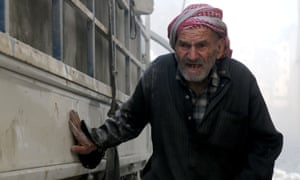 A man shelters by a truck in Aleppo in a photograph taken by Osama Jumaa, who was among the journalists killed in 2016.