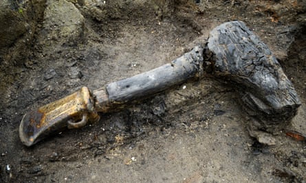 A bronze age socketed axe with a wooden handle, unearthed at Must Farm Quarry, Whittlesey.
