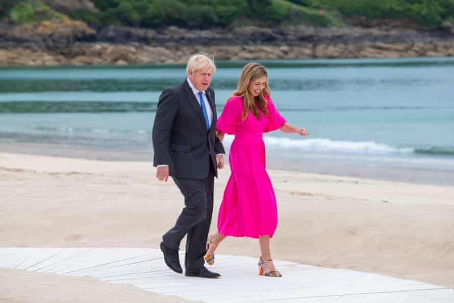 Boris Johnson and Carrie Johnson walk out for the G7 leaders' 'family photo' in Carbis Bay
