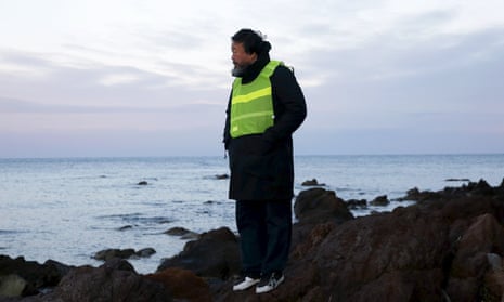 Ai Weiwei stands at a beach where refugees and migrants arrive daily on the Greek island of Lesbos, 