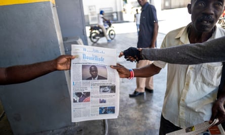 A news vendor sells local newspapers with the news of the assassination of President Jovenel Moïse, in Port-au-Prince.