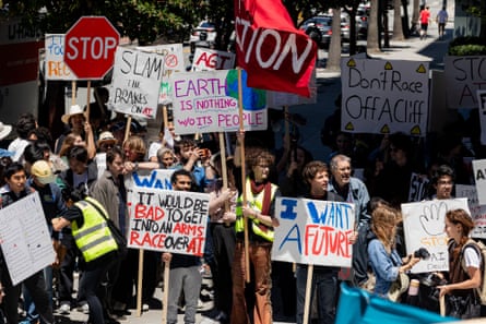 A crowd of people holding protest signs.