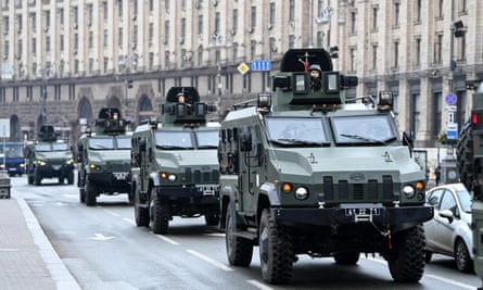 Ukrainian military vehicles pass Independence square in central Kyiv on 24 February 2022.