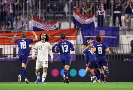 Croatia's Ivan Perisic celebrates scoring their first goal with teammates as Spain's Marc Cucurella looks dejected.