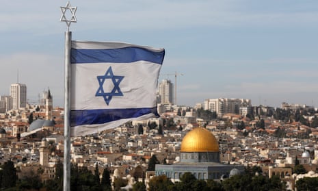 Israeli flag flies overlooking the old city of Jerusalem. Donald Trump will recognise holy city as the capital of Israel according to White House officials.
