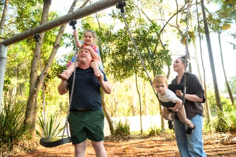 Alex Hogan and his partner Maxine pushing their children, on a swing set at a playground in Everton Hills