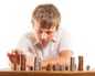 A young boy of 10 counts his money and stacks it upDG6Y4E A young boy of 10 counts his money and stacks it up