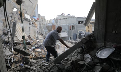  A man inspects a destroyed building after an Israeli airstrike in the southern Gaza Strip city of Rafah, on May 7, 2024. 