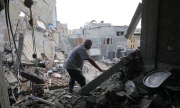  A man inspects a destroyed building after an Israeli airstrike in the southern Gaza Strip city of Rafah, on May 7, 2024. 