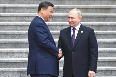 Vladimir Putin and Xi Jinping shake hands during an official welcoming ceremony in front of the Great Hall of the People in Beijing.