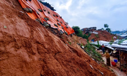 Sandbags are used to try to stabilise a hillside in one camp.