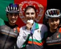 Afghanistan’s Fariba Hashimi celebrates with her medal alongside her sister Yuldoz Hashimi and teammate Zahra Rezayee