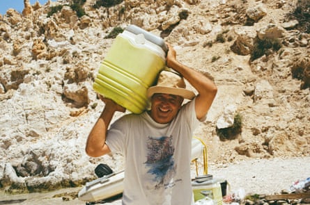 A man carrying a plastic container