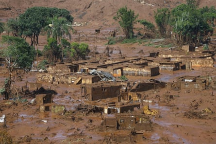 Houses buried in mud at the bottom of a hillside