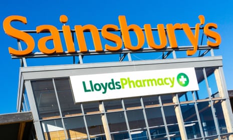 A sign for Sainsbury's and Lloyds Pharmacy on a large Sainsbury's supermarket in King's Lynn, Norfolk