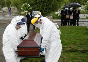 On Friday, June 18, 2021, at Zipaquira Park Cemetery in Zipaquira, Colombia, the cemetery and funeral workers carried a coffin containing the body of a man who died of Covid-19.