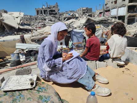 Students doing their homework amid the rubble of buildings in Khan Younis in September 2024.