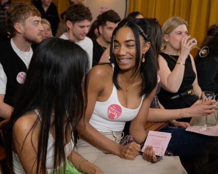 Young women smiling and drinking wine in London pub