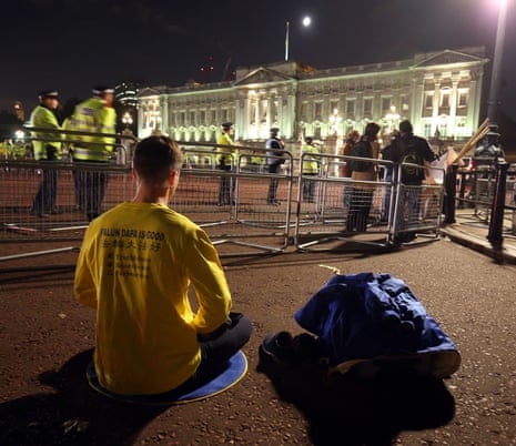 A protestor meditates outside Buckingham Palace ahead of this evening’s state banquet.