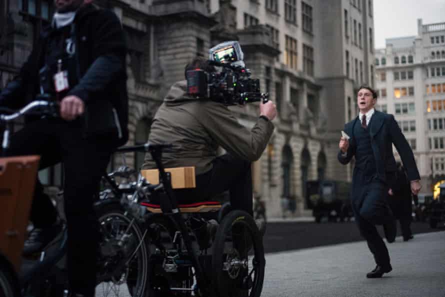George Mackay working down ‘Whitehall’ [actually the side of the Liver building in Liverpool. The camera is ahead of him on a make shift tricyicle