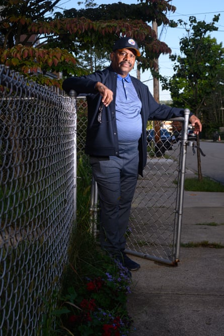 Man leans against fence