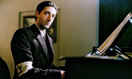Adrien Brody at the piano in a scene from the Pianist, wearing a star of David armband