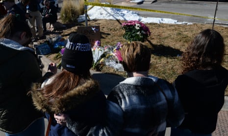 Community members stand at a makeshift memorial to victims of a shooting at a gay nightclub in Colorado Springs.
