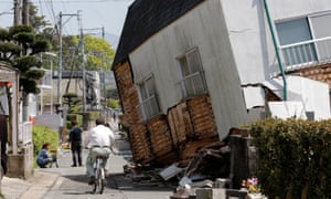 A collapsed house on a street in Mashiki after Thursday’s earthquake