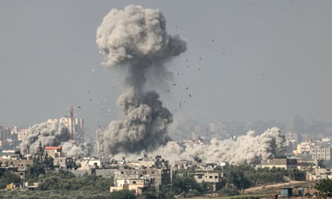 A picture taken from the southern Israeli city of Sderot on 23 October shows smoke and debris ascending over the northern Gaza Strip following an Israeli strike.