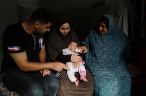 Hiba Swailam carrying her daughter Shahad, with husband Mohammad and her mother in law Khadra in Beit Lahia.