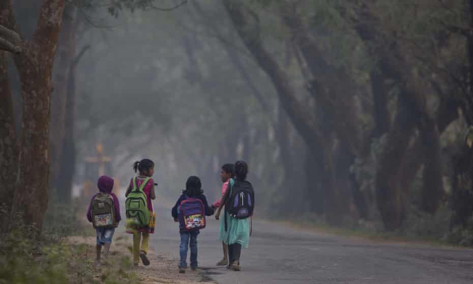 Indian children make their way to school on the outskirts of Gauhati in Assam, north-east India.