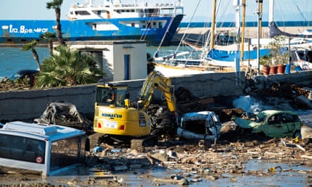 A man works on the damaged port in Casamicciola on 27 November, after heavy rain caused a landslide on the island of Ischia, southern Italy.