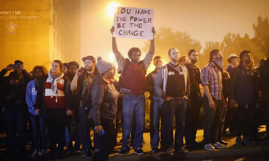 Demonstrators march through the streets of St Louis on 13 October 2014 in St Louis, Missouri following the killing by police of Vonderrit Myers Jr five days earlier and that of 18-year-old Michael Brown in August.