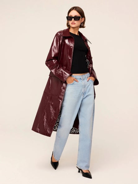 Model wearing vinyl coat and jeans
