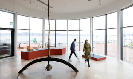 Two people move around works by George Wyllie at the Wyllieum