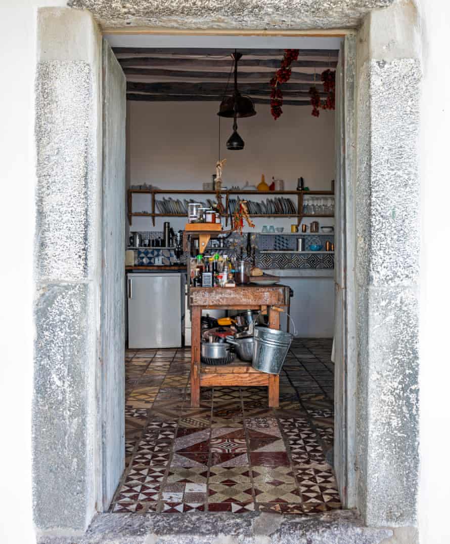 A chromatic doorway opening onto to a room with mismatched level tiles.