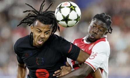 Jules Koundé grapples with Mohammed Salisu of Monaco in the Champions League
