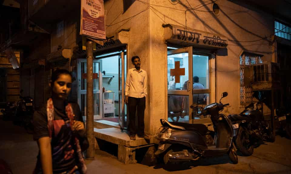 A man stands outside Sunil Sagar’s clinic, which caters to local population of Bhagwanpur Khera, New Delhi, India. The patient can consult Dr Sagar at a nominal fee of 70 INR ($1 approximately).