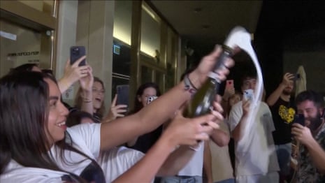 Natali Zangauker, sister of hostage Matan Zangauker, pops a bottle of champagne while reacting to news that Israel and Hamas have agreed to the first phase of US president Donald Trump’s plan for Gaza, at Hostages Square in Tel Aviv.