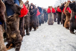 Participants lined up in bear costume, with red tassels