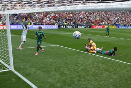 The ball flies into an empty net watched by Senegal and Belgium players