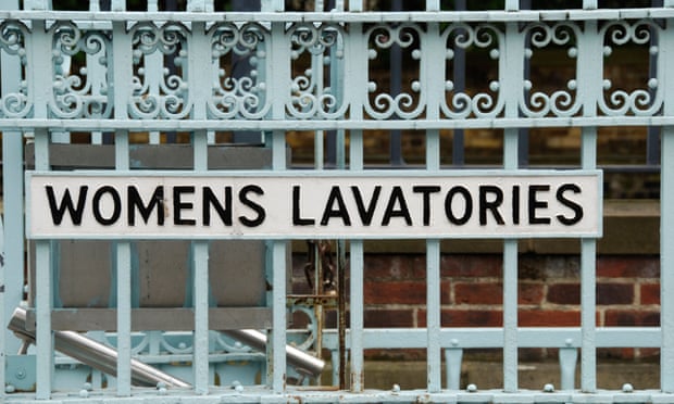 A close up of a women's lavatories sign on iron railings