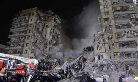 Rescuers search for people amid a scene of devastation at an apartment block after Russian missile attacks in Dnipro, south-central Ukraine, on Saturday that killed at least 14 people