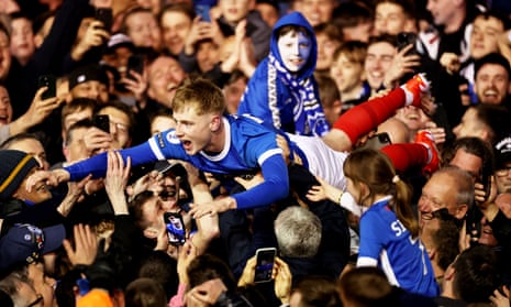 Portsmouth’s Paddy Lane does some crowd surfing at full-time.