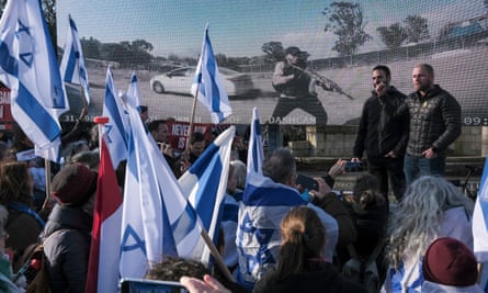 Pro-Israel activists gather in front of a screen near the international court of justice in The Hague