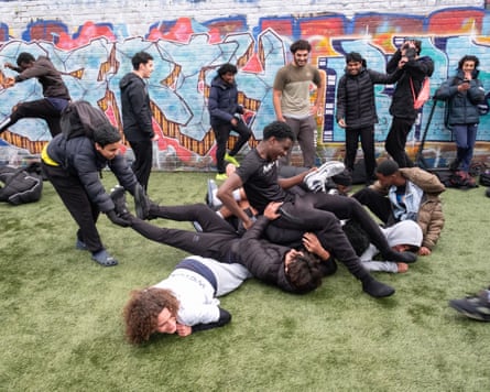 A group of boys pile on each other
