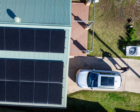 An aerial view shows solar panels on the roof and an EV in the driveway of a home in Porepunkah, Victoria, Australia