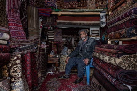 Sayed Jafar, a carpet vendor, sits in his shop in Kabul
