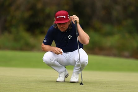 Cameron Smith of Australia lines up a putt on the 15th green on day one